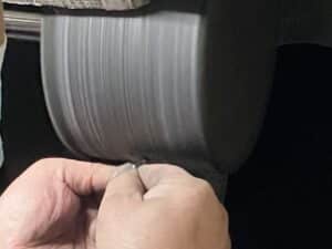 Artisan performing precision mirror polishing on titanium jewelry.